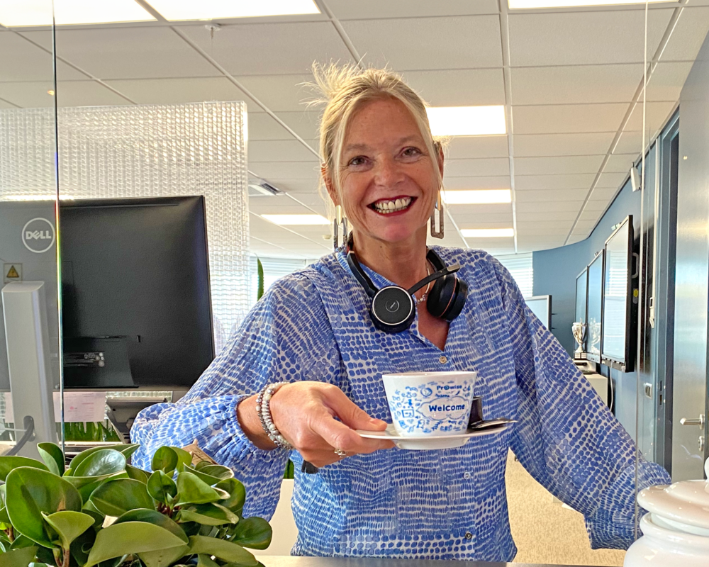 Receptionist offers a cup of coffee