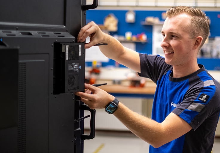 Prowise employee places the PC Module in the Prowise Touchscreen Ten